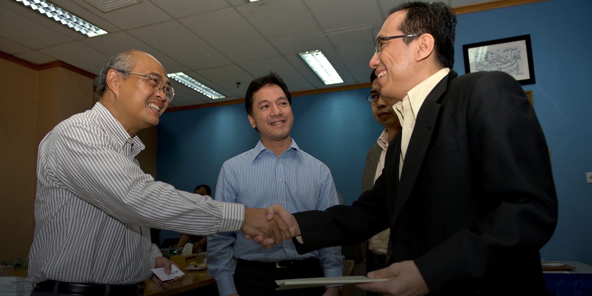 Men shaking hands and smiling