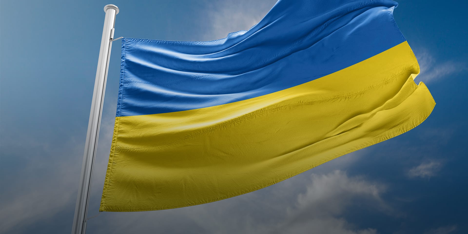 The flag of Ukraine waving on a flagpole.