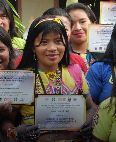 Several women posing for a photo. Each is holding a certificate.