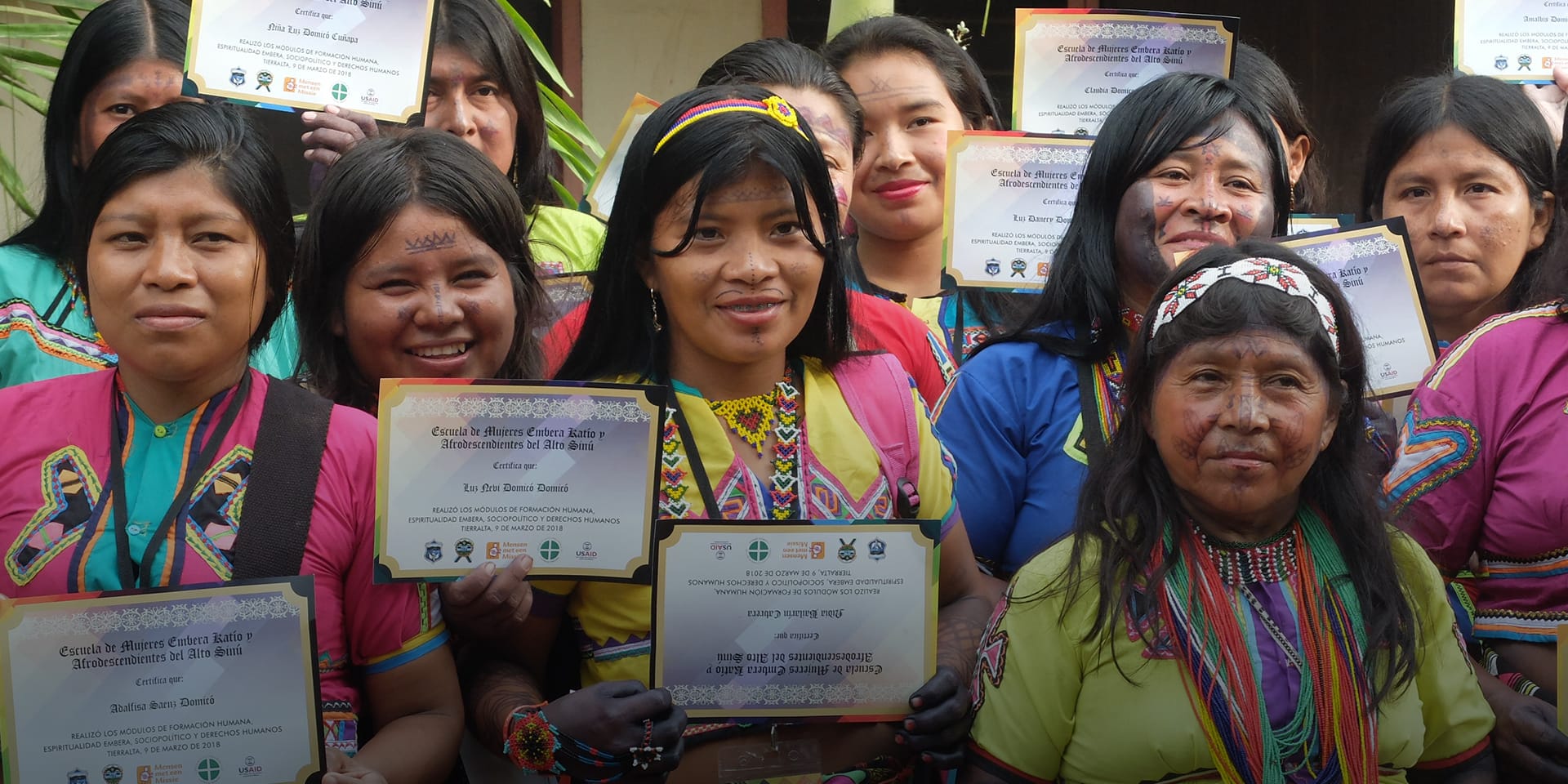 Several women posing for a photo. Each is holding a certificate.
