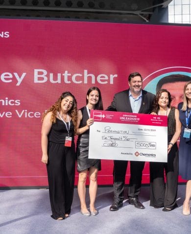 Image of four women posing with Jamey Butcher, President and CEO of Chemonics. They are holding a large check made out for $5,000.