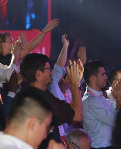 Attendees of the 2019 UNLEASH Global Innovation Lab cheer during a general session.