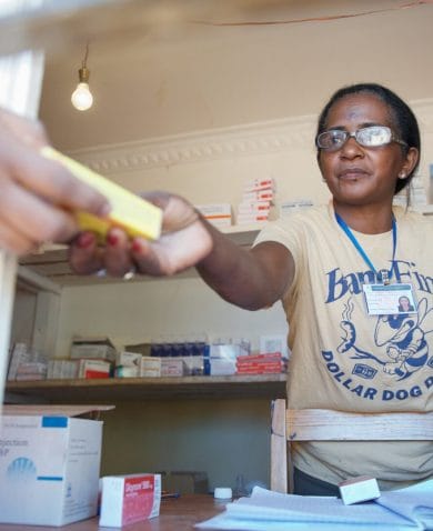 Mada, a pharmacist in Madagascar, hands over a box of medicines to a patient. Credit: Lan Andrian for GHSC-PSM (2017)